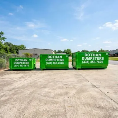Roll-off dumpster rental in Dothan AL showing three different size green Dothan Dumpsters containers